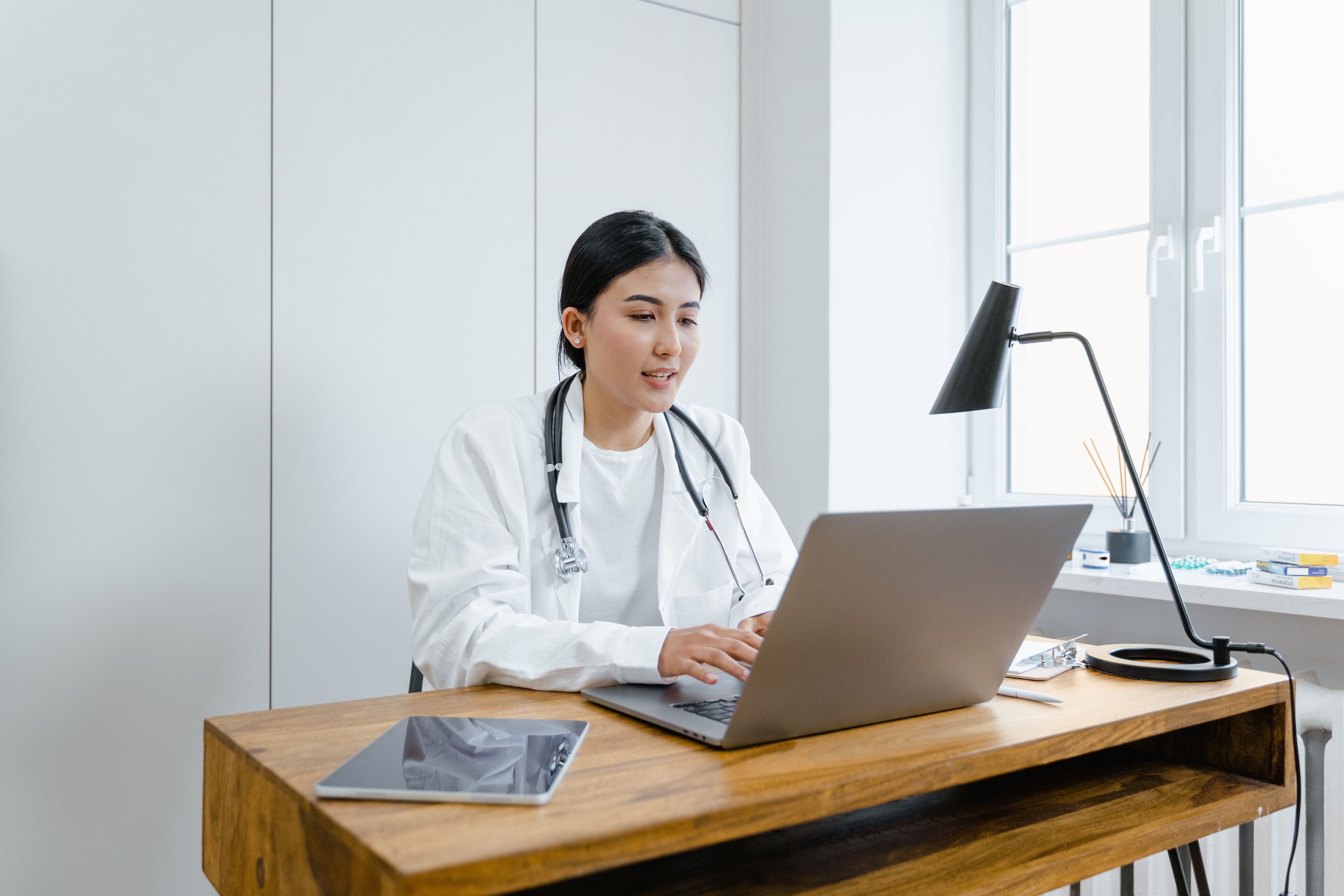 Doctor sitting at a desk with a laptop