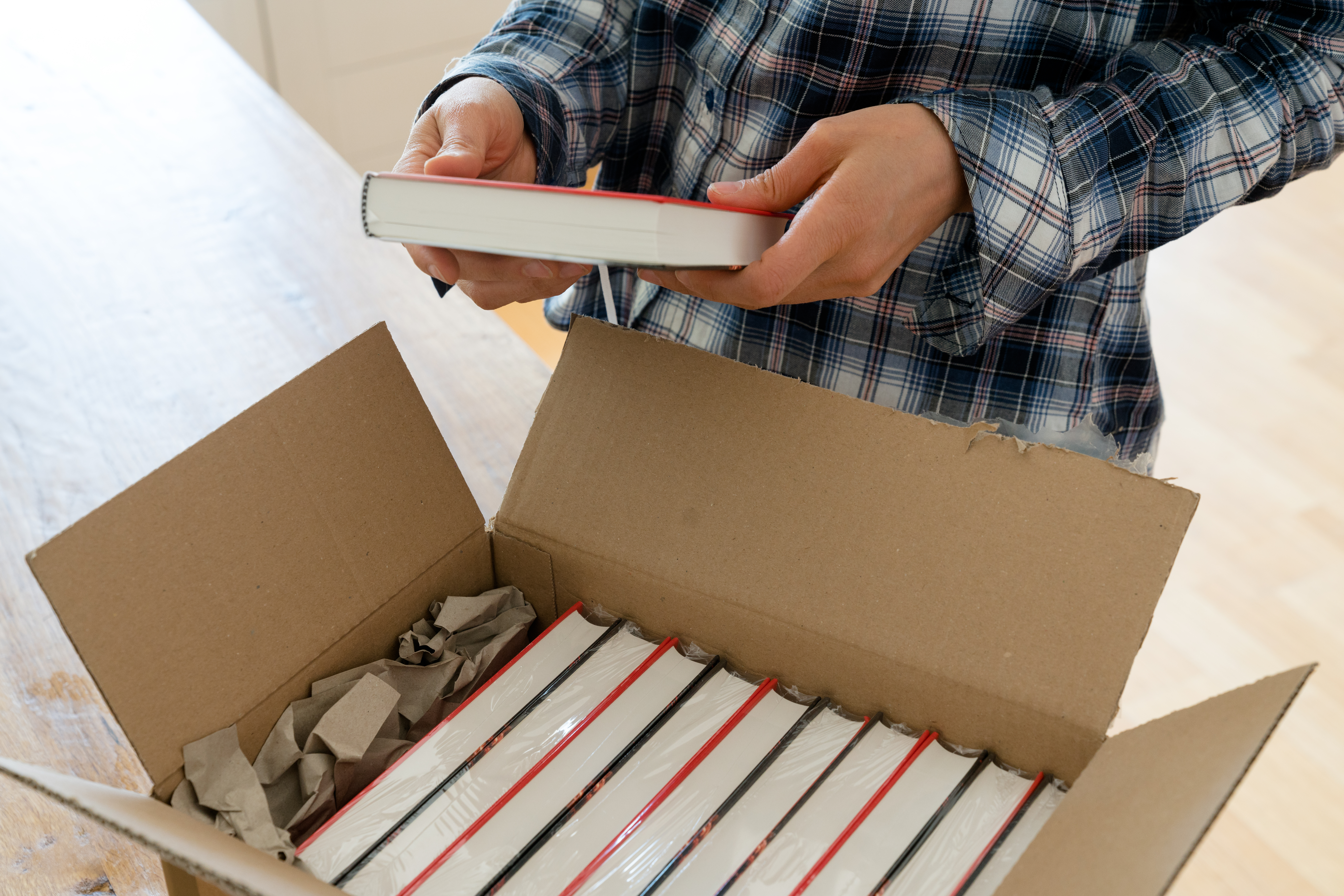 author opens box of book samples