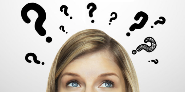 Woman Surrounded by Question Marks